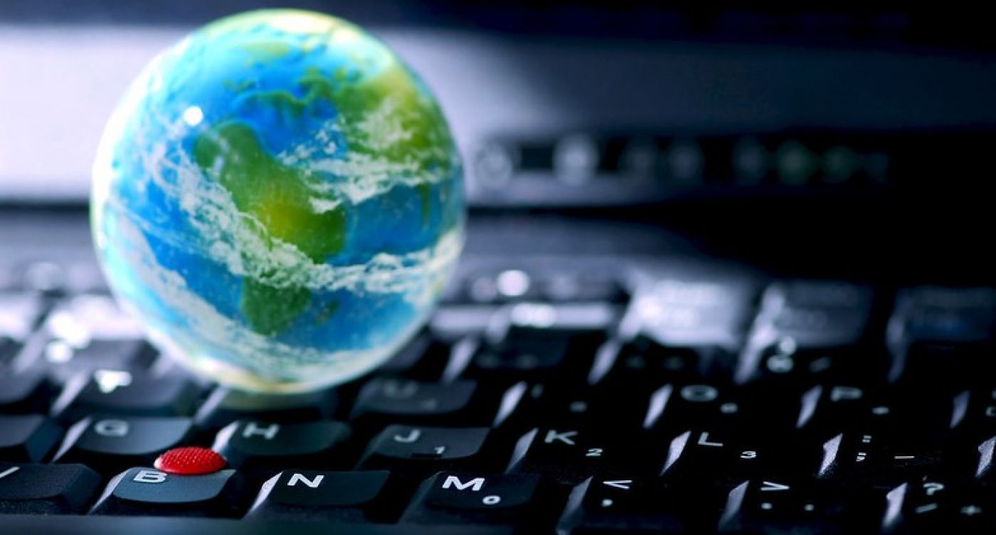the image of planet Earth sitting on top of a computer keyboard