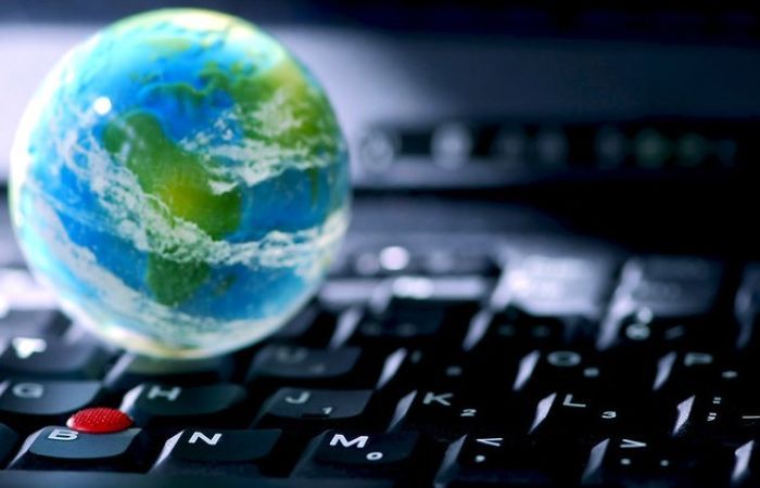 the image of planet Earth sitting on top of a computer keyboard